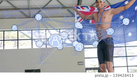 Holding Aussie flag, swimmer posing inside pool, wearing cap medal jammers with overlay, copy space Holding Aussie flag, swimmer posing inside pool, wearing cap medal jammers with overlay, copy space 139428413
