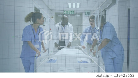 Pushing care team moving bed down hospital corridor, with scrubs, lab coat, stethoscopes, lanyards Pushing care team moving bed down hospital corridor, with scrubs, lab coat, stethoscopes, lanyards 139428552