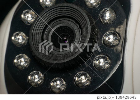 Closeup of security camera lens surrounded by infrared leds surveillance technology device for monitoring safety and protection in indoor or outdoor setting Closeup of security camera lens surrounded by infrared leds surveillance technology device for monitoring safety and protection in indoor or outdoor setting 139429645