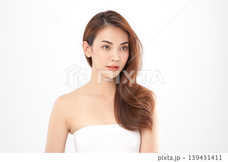 A beautiful young Asian woman with clean, fresh skin against a white background. Skincare, facial treatment, cosmetology, beauty, and spa. An elegant portrait of an Asian woman. 139431411