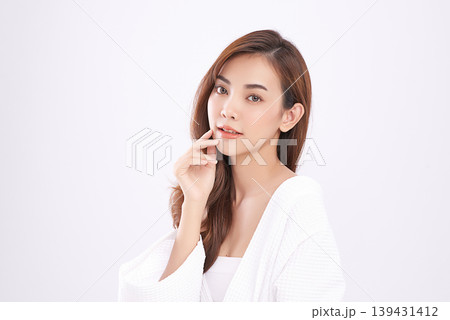 A beautiful young Asian woman with clean, fresh skin against a white background. Skincare, facial treatment, cosmetology, beauty, and spa. An elegant portrait of an Asian woman. 139431412