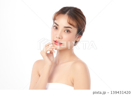 A beautiful young Asian woman with clean, fresh skin against a white background. Skincare, facial treatment, cosmetology, beauty, and spa. An elegant portrait of an Asian woman. 139431420