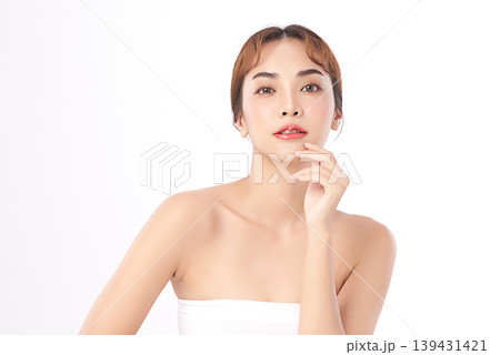 A beautiful young Asian woman with clean, fresh skin against a white background. Skincare, facial treatment, cosmetology, beauty, and spa. An elegant portrait of an Asian woman. 139431421