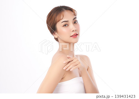 A beautiful young Asian woman with clean, fresh skin against a white background. Skincare, facial treatment, cosmetology, beauty, and spa. An elegant portrait of an Asian woman. 139431423