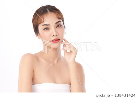 A beautiful young Asian woman with clean, fresh skin against a white background. Skincare, facial treatment, cosmetology, beauty, and spa. An elegant portrait of an Asian woman. 139431424