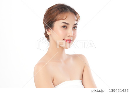 A beautiful young Asian woman with clean, fresh skin against a white background. Skincare, facial treatment, cosmetology, beauty, and spa. An elegant portrait of an Asian woman. 139431425