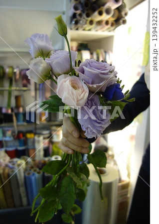 Hand Holding Floral Bouquet in Craft Store Hand Holding Floral Bouquet in Craft Store 139432252