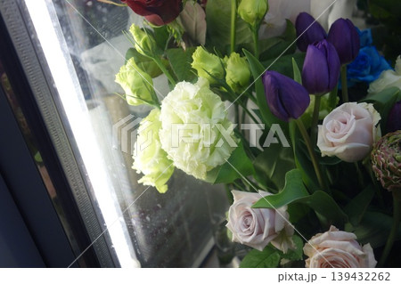 Fresh Floral Bouquet with Roses and Tulips Near Window 139432262