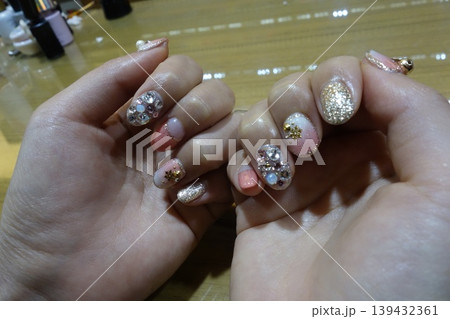 Elegant Pink and Gold Nail Art on Hands Elegant Pink and Gold Nail Art on Hands 139432361