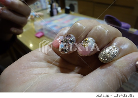 Close-up of Intricate Nail Art with Glitter and Rhinestones 139432385