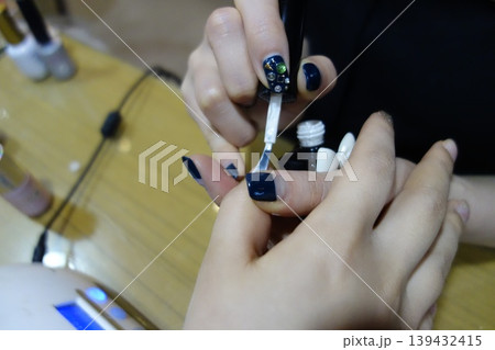 Nail Artistry: Detailed Nail Polish Application Close-up Nail Artistry: Detailed Nail Polish Application Close-up 139432415