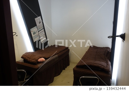 Small Dormitory Room with Two Beds and Information Posters 139432444