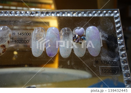 Nail Art Display with Sparkling Designs and Price Tags 139432445