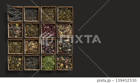 Collection of various loose tea leaves arranged on wood with vibrant petals and textured leaves Collection of various loose tea leaves arranged on wood with vibrant petals and textured leaves 139432530