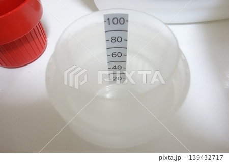 Measuring Cup with Scale and Red Cap Measuring Cup with Scale and Red Cap 139432717