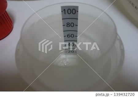 Measuring Cup with Water Level 139432720