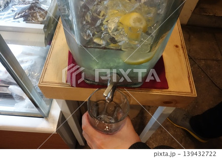 Lemonade Dispenser with Ice and Lemon Slices Lemonade Dispenser with Ice and Lemon Slices 139432722
