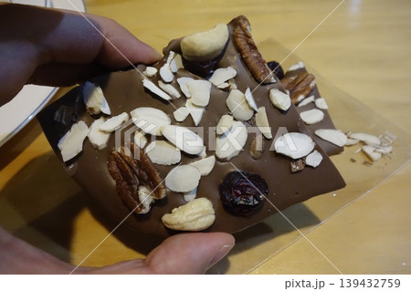 Hand Holding Nut and Fruit Chocolate Bar Hand Holding Nut and Fruit Chocolate Bar 139432759