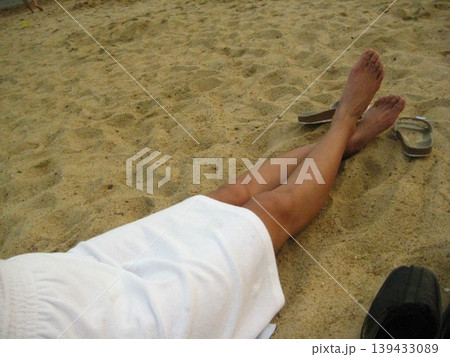 Beach Legs with Sandals on Sandy Shore Beach Legs with Sandals on Sandy Shore 139433089