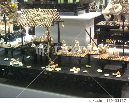Miniature Animal Village Scene with Bamboo Structures Miniature Animal Village Scene with Bamboo Structures 139433127