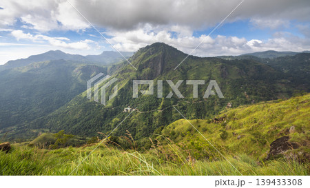 Ella rock mountain, view from Little Adam's Peak in Sri Lanka. Dramatic Mountain Landscape with Lush Green Hills and Cloudy Sky, Offering a Breathtaking Natural Vista 139433308