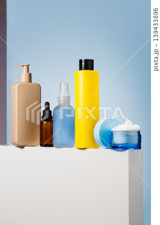 Skincare product lineup on blue pedestal Skincare product lineup on blue pedestal 139433896