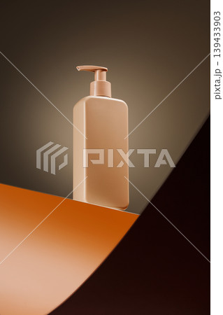 Beige pump bottle on dark warm backdrop 139433903