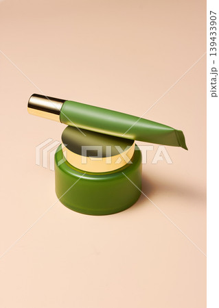 Luxury Cosmetic Tube Balanced on Green Jar Luxury Cosmetic Tube Balanced on Green Jar 139433907