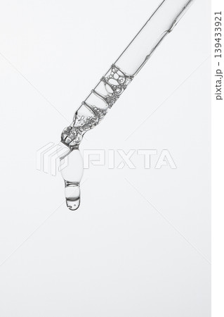 Clear Cosmetic Serum Hanging From Pipette 139433921