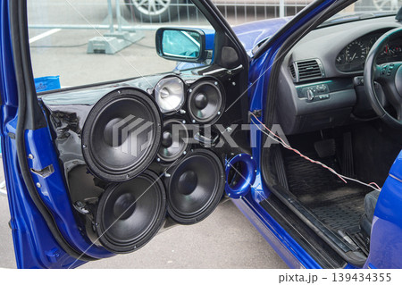 Custom car audio system with multiple speakers installed in blue vehicle door panel interior Custom car audio system with multiple speakers installed in blue vehicle door panel interior 139434355