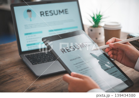 People are reviewing job applications before filling out their resume on the job application form in order to apply for a job at a company 139434380