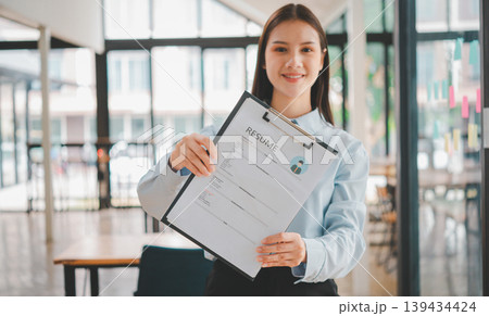 Asian young holding resume applying to apply for a job 139434424