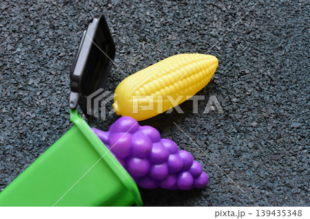 Toy food in a small green bin for play and recycling concepts 139435348