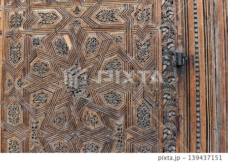 Carved wooden door details with geometric patterns, Bou Inania Madrasa. Fez, Morocco Carved wooden door details with geometric patterns, Bou Inania Madrasa. Fez, Morocco 139437151