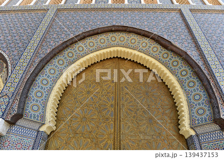 Brass door with Arabic calligraphy and Moroccan zellij mosaic tilework. Royal Palace, Fez, Morocco Brass door with Arabic calligraphy and Moroccan zellij mosaic tilework. Royal Palace, Fez, Morocco 139437153