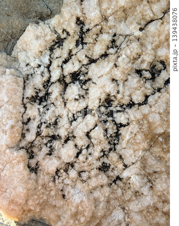 high-angle view of a textured rock surface, likely a section of granite or a similar igneous or metamorphic formation. high-angle view of a textured rock surface, likely a section of granite or a similar igneous or metamorphic formation. 139438076