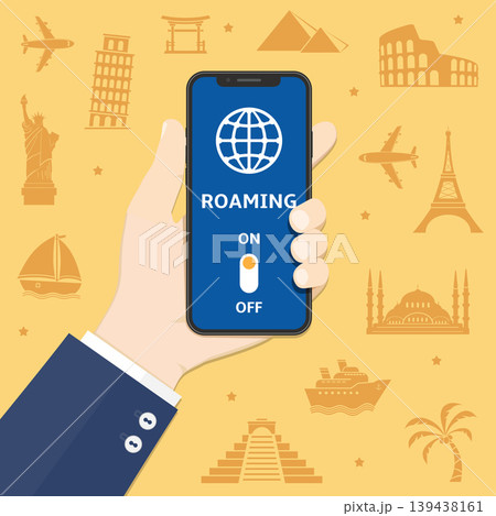 Smartphone in hand with international roaming on screen against world landmarks silhouette background 139438161