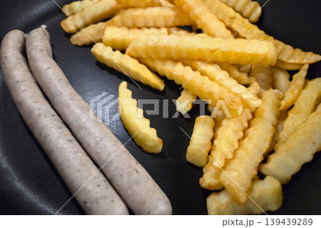 Savory Breakfast Scene with Sausages and Crispy Crinkle-Cut Fries for Food Design 139439289