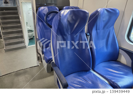 Interior of Modern Train with Blue Seats and Compact Design for Comfortable Travel Experience 139439449