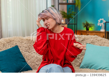 Young woman doing facepalm gesture showing frustrated irritated and tired facial expression reaction Young woman doing facepalm gesture showing frustrated irritated and tired facial expression reaction 139439625
