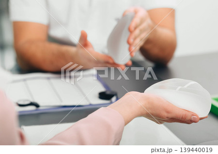 Woman choosing silicone breast implant for new breast size Woman choosing silicone breast implant for new breast size 139440019