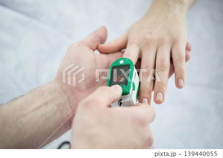 Patient Finger Pulse Trace Oximeter close-up. Taking Pulse 139440055