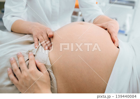 female doctor examining pregnant stomach, close-up pregnancy female doctor examining pregnant stomach, close-up pregnancy 139440084