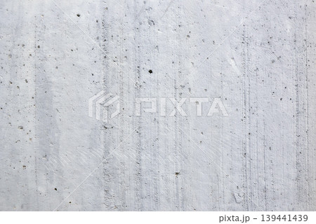Concrete surface displays its texture and lines under natural light in industrial area during day. Concrete surface displays its texture and lines under natural light in industrial area during day. 139441439
