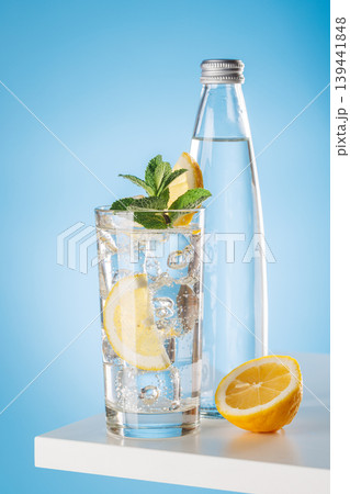 Sparkling water with lemon and bottle on blue background refreshment 139441848