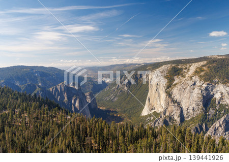 Mountain landscape in Yosemite National Park with towering granite cliffs, green forests Mountain landscape in Yosemite National Park with towering granite cliffs, green forests 139441926