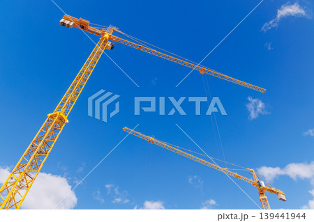 Construction cranes against blue sky Construction cranes against blue sky 139441944