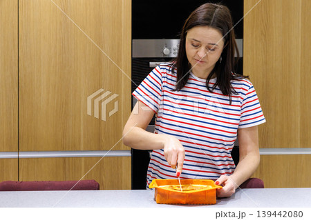 Woman cooking food at home kitchen Woman cooking food at home kitchen 139442080