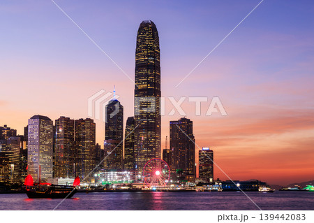 Hong Kong city skyline at sunset with glowing sky and skyscrapers Hong Kong city skyline at sunset with glowing sky and skyscrapers 139442083