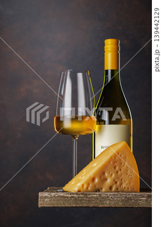 White wine glass with cheese on rustic table White wine glass with cheese on rustic table 139442129